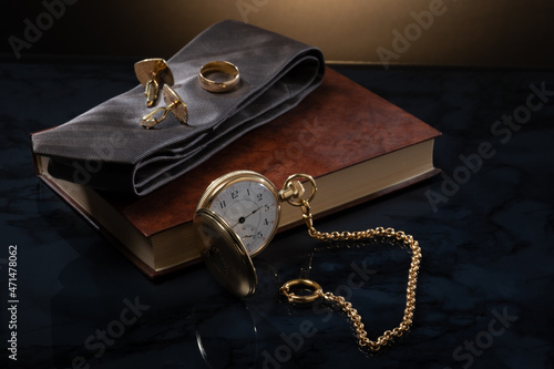 Closeup of a vintage watch and some men's jewelry against studio background. Men's business accessory. © Marko Hannula