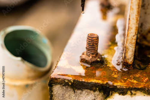 Rusty Nut and Bolt corrosive from acid rain water humidity destroying structure and strength.