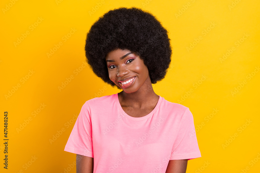 Photo of young attractive lovely african girl happy positive smile wear t-shirt isolated over yellow color background Photo of young attractive lovely african girl happy positive smile wear t-shirt isolated over yellow color background