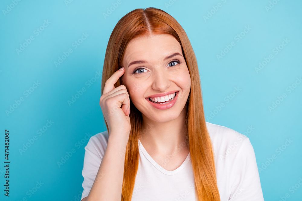 Photo of satisfied friendly person finger on temple toothy smile look camera isolated on blue color background