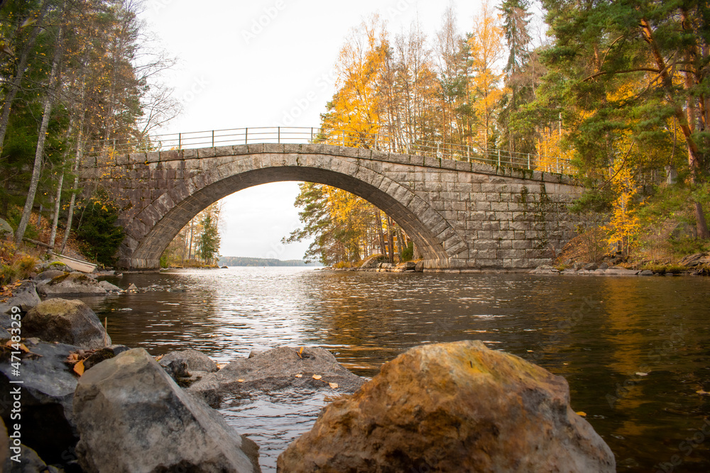 Old stone bridge Aunessilta on autumn in Tampere, Finland