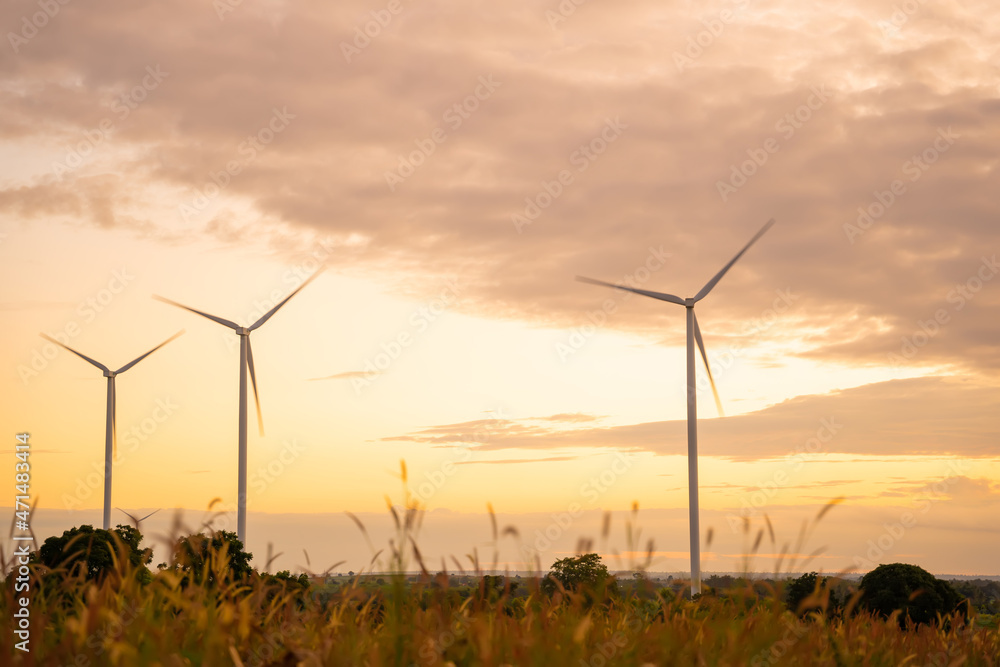 Obraz premium Wind turbines of global ecology with cloud background on the sky. alternative electricity source to be sustainable resources in the future. Clean energy concept saves the world