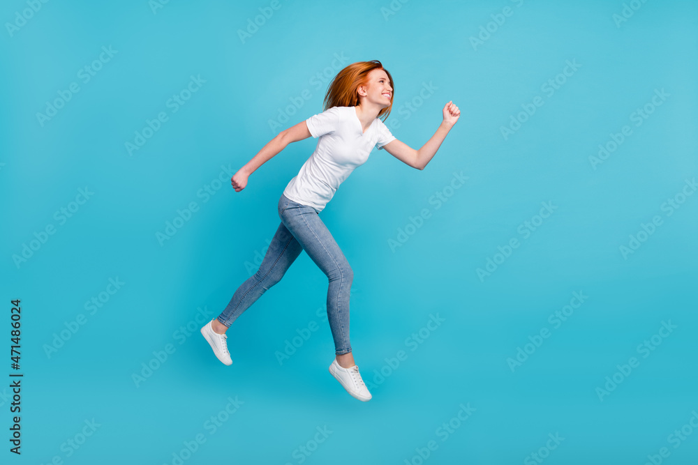 Full body profile side photo of young girl happy positive smile go walk run hurry sale jump isolated over blue color background
