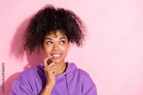 Portrait of charming cheerful minded lady finger touch lip look empty space isolated on pink color background
