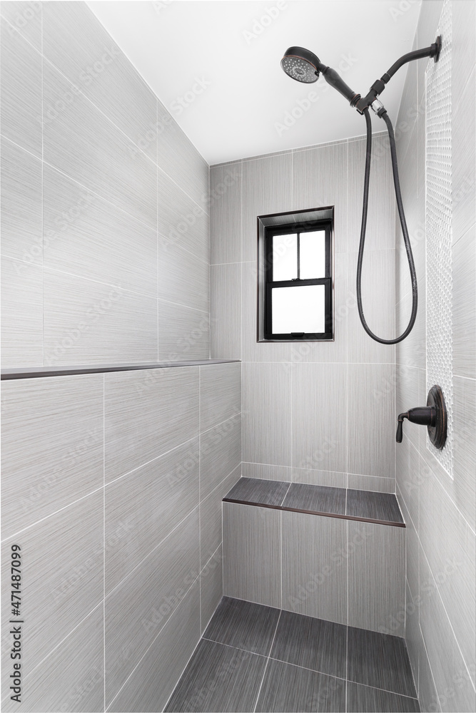 New black shower head on holder in white tiled bathroom in modern apartment  Stock Photo - Alamy