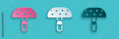 Paper cut Amanita muscaria or fly agaric hallucinogenic toadstool mushroom icon isolated on blue background. Spotted poisonous mushroom. Paper art style. Vector