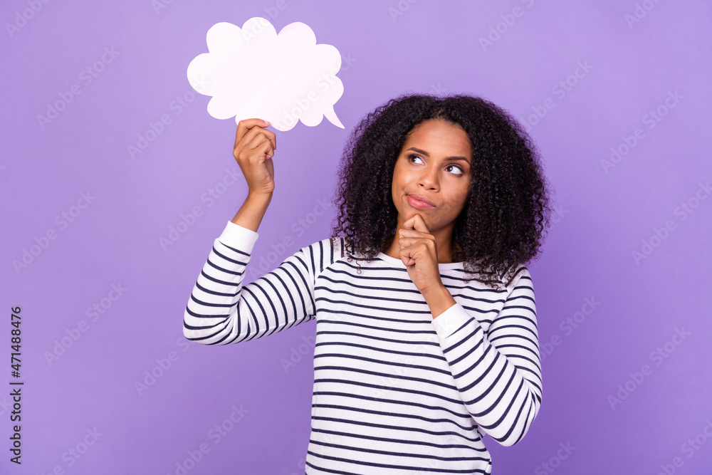 Photo of thoughtful minded, young lady hold speech bubble brainstorming isolated on violet color background Photo of thoughtful minded, young lady hold speech bubble brainstorming isolated on violet color background
