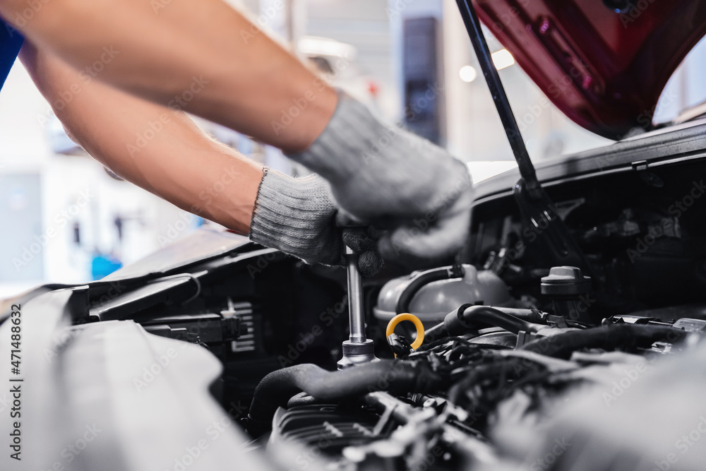 Auto mechanic working in car service garage Auto mechanic working in car service garage