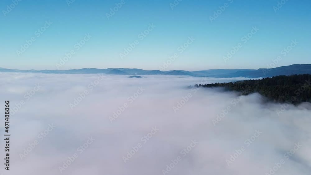 Mountains among clouds under blue sky, sunrise in national landscape nature park in Czech republic. Mountains among clouds under blue sky, sunrise in national landscape nature park in Czech republic.