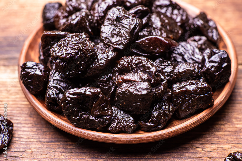 Dried prunes on a wooden background. Dry fruits. Dried prunes on a wooden background. Dry fruits.