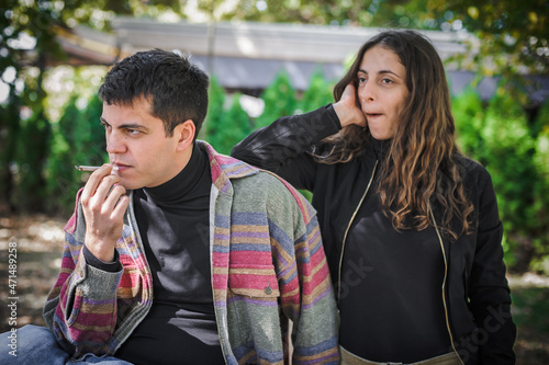 Young couple, woman and man, smoking cannabis marijuana ganja joint