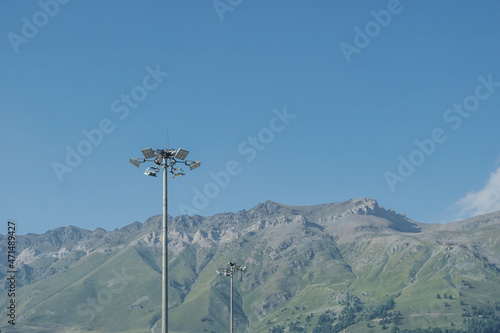 High masts with floodlights on the ski slope.