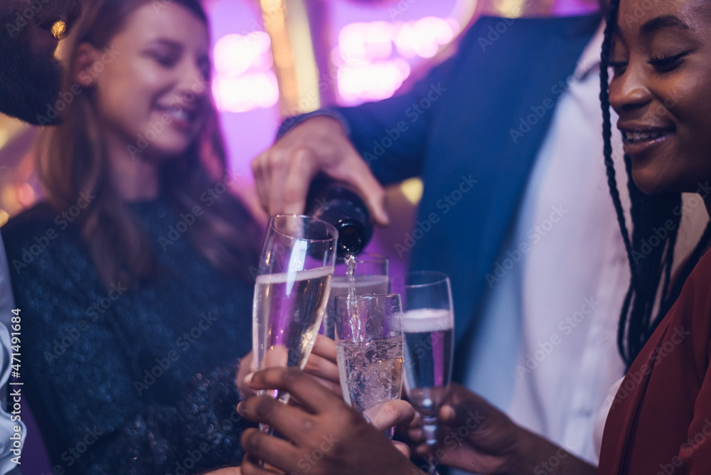 Friends celebrate New Year's Eve while drinking champagne