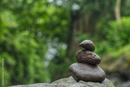 Stacked stones on the bank of the Opak river, Yogyakarta, Indonesia. Photo with the concept of harmony, wellness and balance with selective focus.