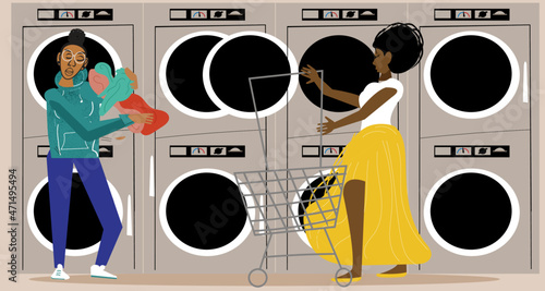Gay couple in laundromat while partner is pushing the laundry cart 