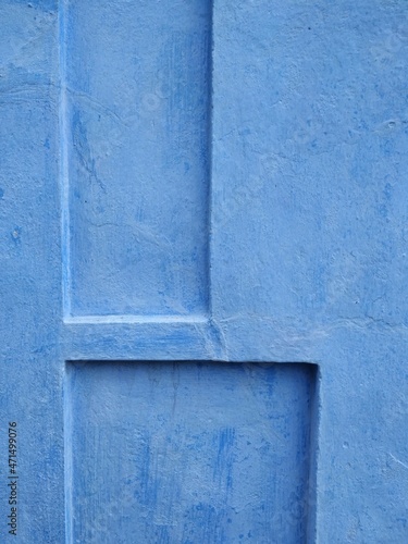 Bright blue wall of the house painted with calcimine