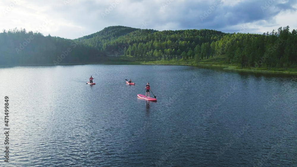 People kayaking on the crystal water lake. Aerial footage