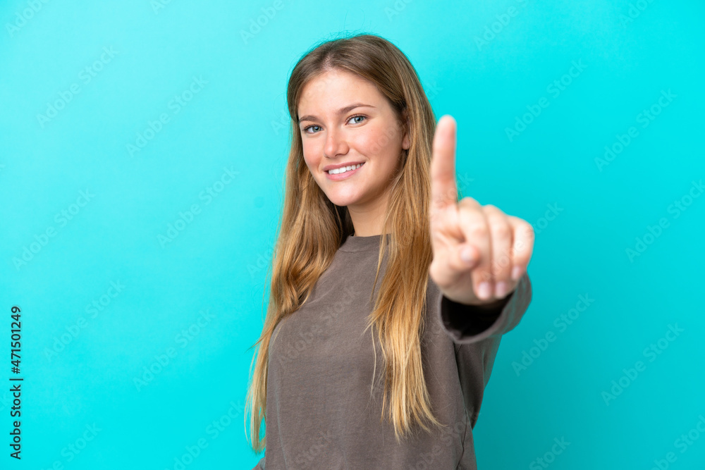 Young blonde woman isolated on blue background showing and lifting a finger Young blonde woman isolated on blue background showing and lifting a finger
