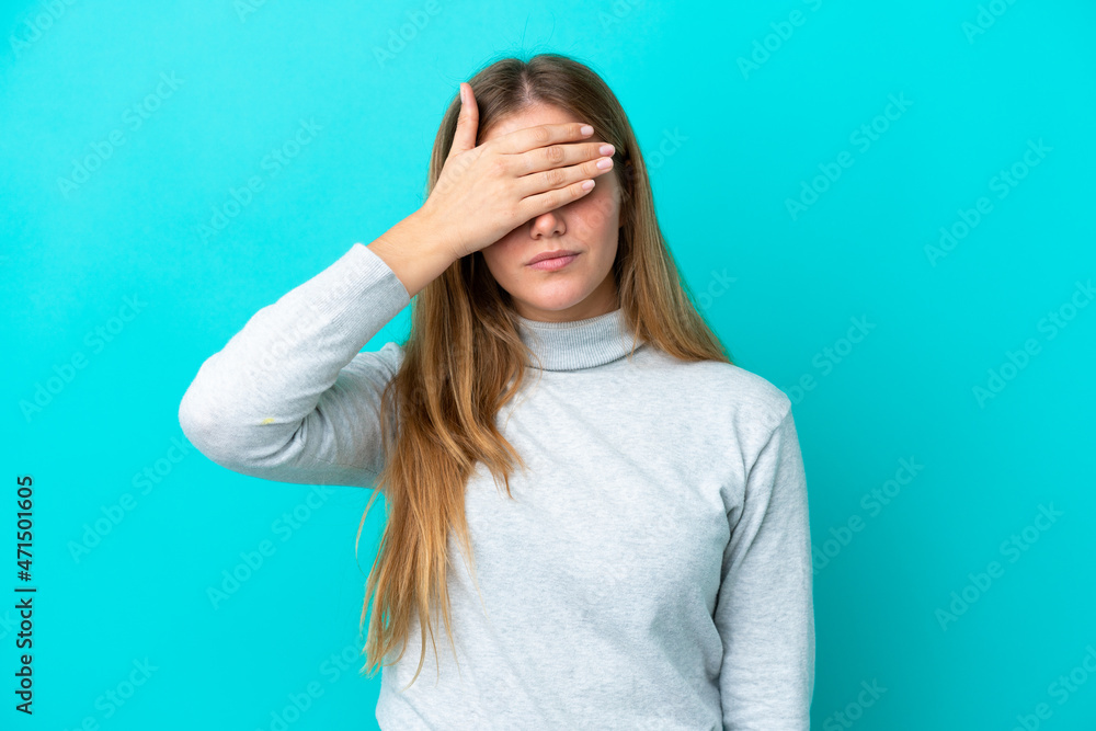 Young blonde woman isolated on blue background covering eyes by hands. Do not want to see something Young blonde woman isolated on blue background covering eyes by hands. Do not want to see something