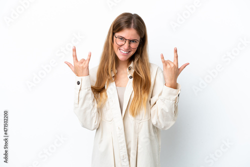 Young blonde woman isolated on white background making horn gesture