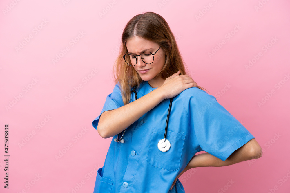 Young surgeon doctor woman isolated on pink background suffering from pain in shoulder for having made an effort