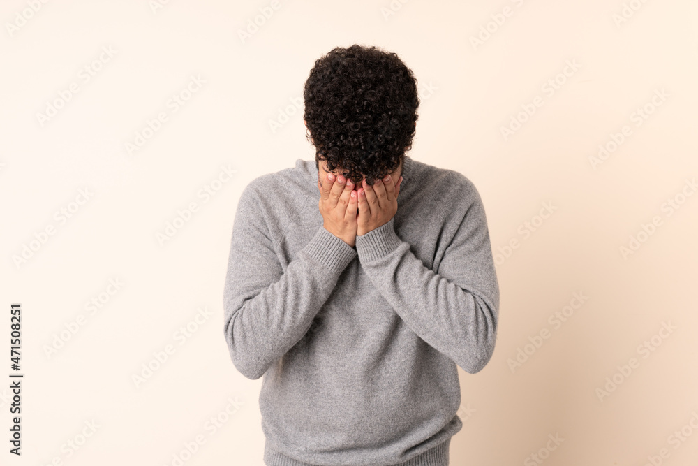 Young Moroccan man isolated on beige background with tired and sick expression Young Moroccan man isolated on beige background with tired and sick expression