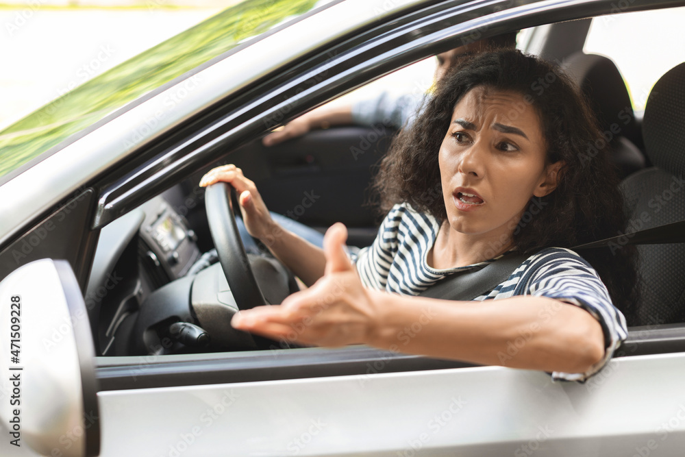 Indignant brunette lady driver fighting on the road