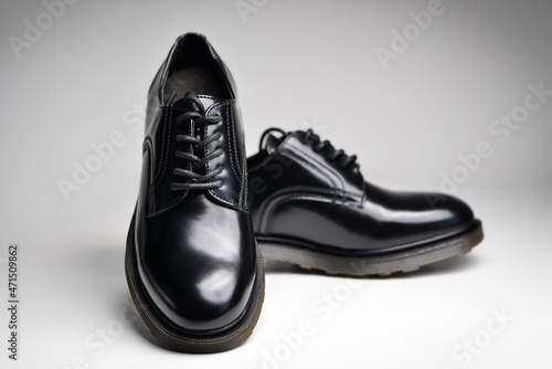 Black leather male shoes, white background. Classic male black leather shoes. 