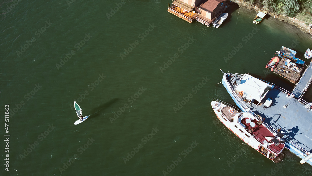 Surfboarding on a city urban river. Drone aerial photo. Surfboarding on a city urban river. Drone aerial photo.