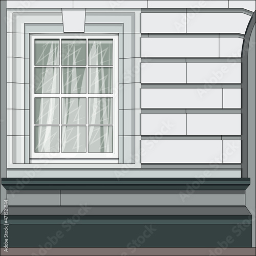 The facade of the building with a window in the classicism style.