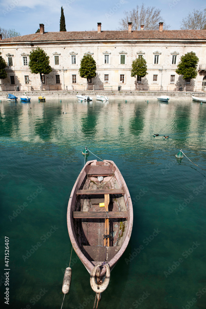 A boat moored in the canal in Peschiera-garda lake-Italy