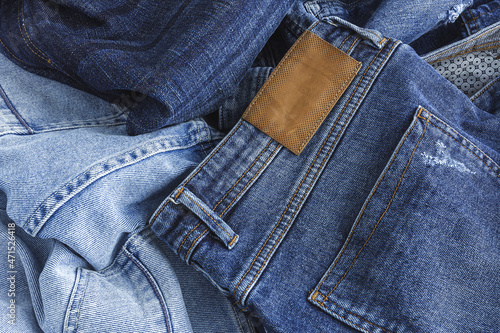 Heap of blue jeans in studio photo