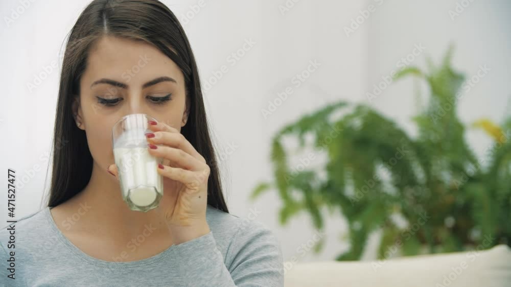 4k slow motion video of woman drinking milk and smiling. 4k slow motion video of woman drinking milk and smiling.