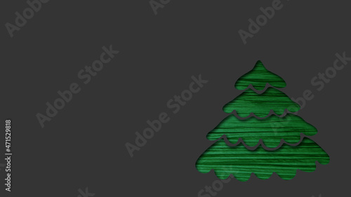 abstract christmas card with copy space - green christmas tree cut out from dark grey paper 