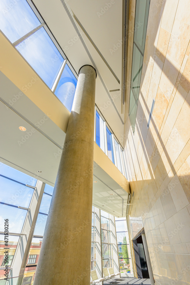 Obraz premium Window and blue sky. Abstract fragment of the architecture of modern lobby, hallway of the luxury hotel, shopping mall, business center in Vancouver, Canada. Interior design.