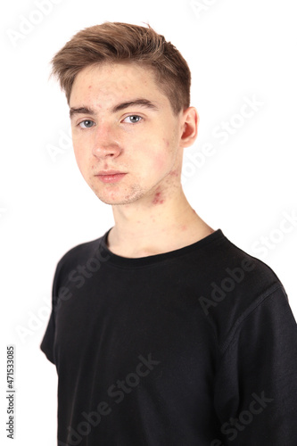 Portrait of a teenager, boy in puberty isolated on a white background