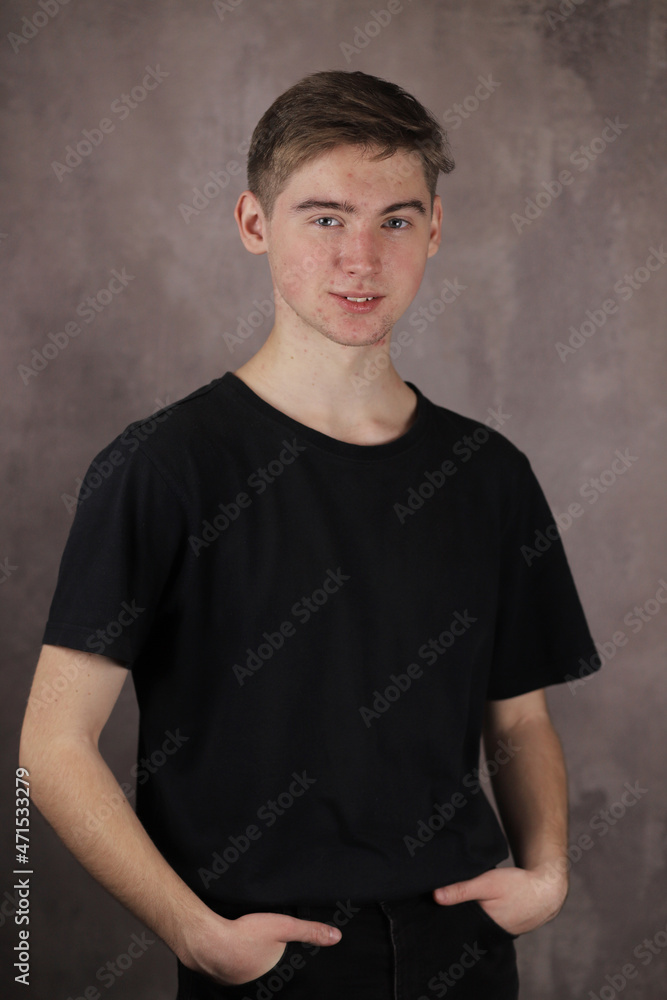 Portrait of a Handsome teenage boy on a gray background Portrait of a Handsome teenage boy on a gray background