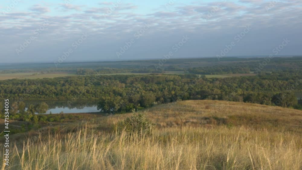 the turn of a large river against the background of a forest and a sky the turn of a large river against the background of a forest and a sky