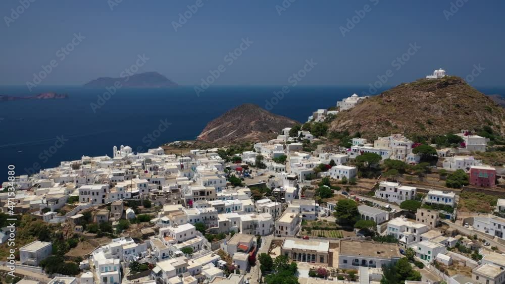 Aerial drone video of main village of Plaka, main village or chora of Milos island featuring uphill castle and scenic views to Aegean sea, Cyclades, Greece Aerial drone video of main village of Plaka, main village or chora of Milos island featuring uphill castle and scenic views to Aegean sea, Cyclades, Greece