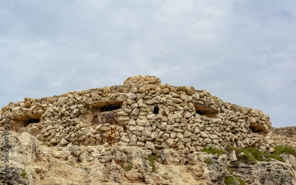 Camouflaged WW2 stone military pillbox at Qrendi, Malta. This Pillbox was tasked with defending the entrance to Wied iz- Zurrieq inlet.