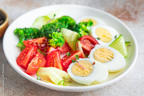 salad vegetables and egg broccoli, tomato, cucumber, meal snack on the table copy space food background rustic. top view keto or paleo diet veggie vegetarian food