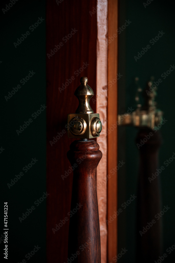 an old brown door with a metal handle. an antique object.