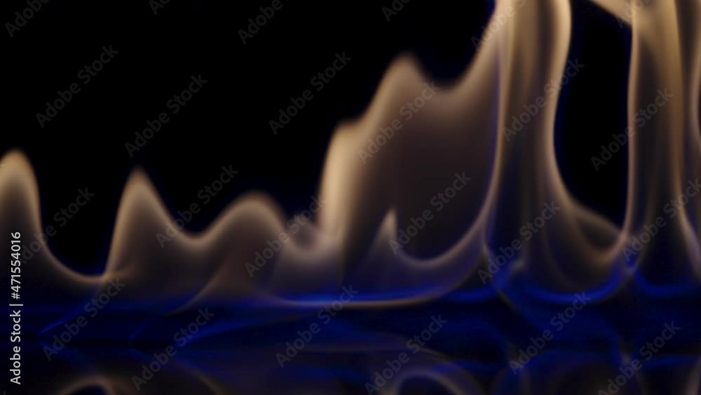 Flammable liquid or petrol stains on black reflective background flash