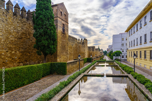 Outer wall of the Andalusian city of Cordoba with fountains and colored houses.