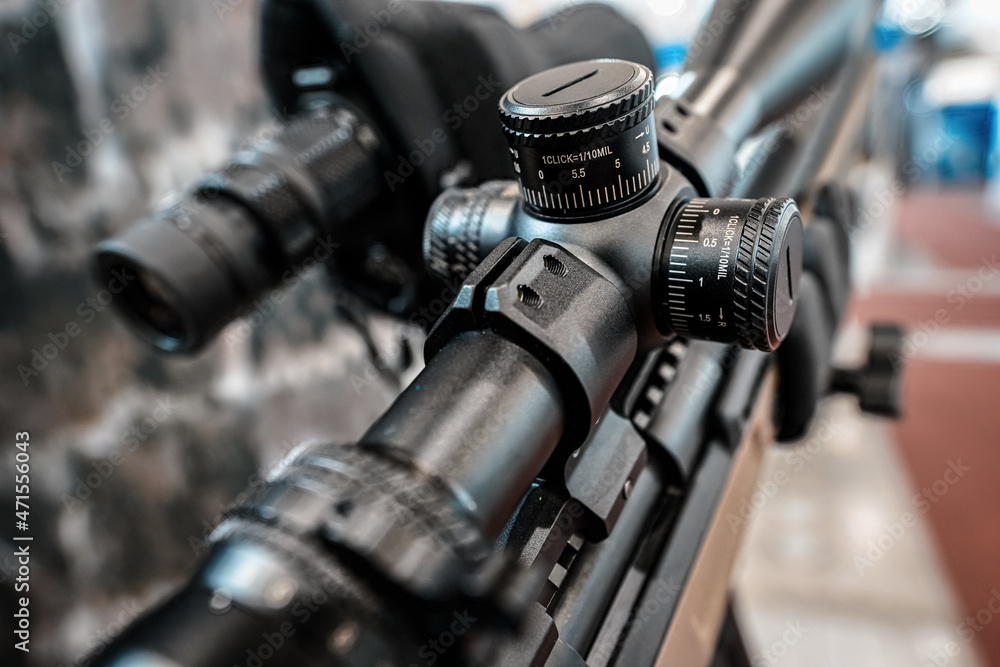 custom made wallpaper toronto digitalBlack shooting scope optics mounted on rifle displayed at weapons exhibition fair, closeup detail to adjustment knobs