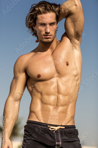 Sexy portrait of muscular handsome topless male model at the beach. Hot body!