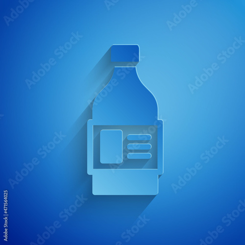 Paper cut Plastic bottle for laundry detergent, bleach, dishwashing liquid or another cleaning agent icon isolated on blue background. Paper art style. Vector
