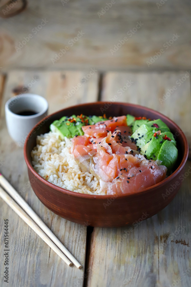 Selective focus. Poke bowl with salmon and avocado. Healthy food. Rice with avocado and fish. Sushi bowl. Selective focus. Poke bowl with salmon and avocado. Healthy food. Rice with avocado and fish. Sushi bowl.