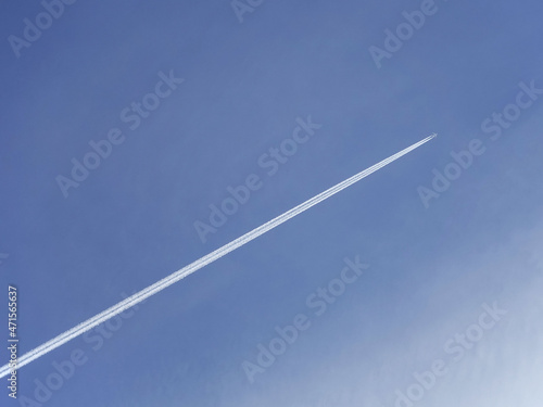 Jet leaving vapor trail contrail across sky
