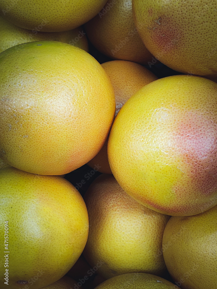 Fototapeta premium A lot of yellow grapefruits in the bpx